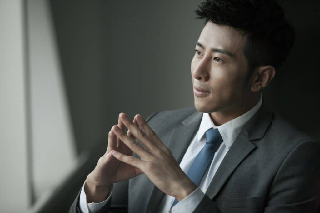 Young businessman thinking about website maintenance cost in Malaysia