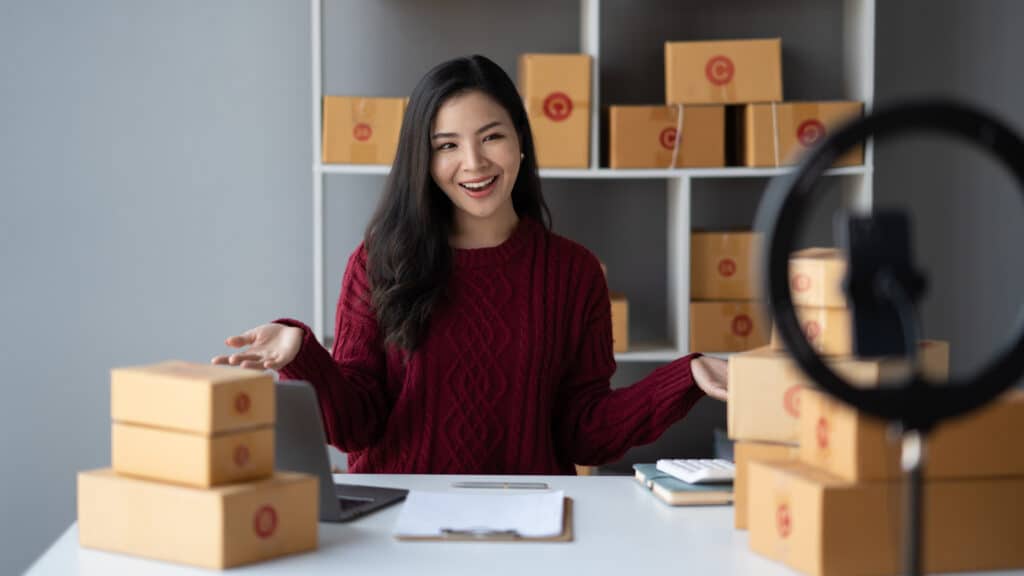 What is influencer marketing ? Image of Asian woman vlogger and online influencer recording video content for online marketing and selling.